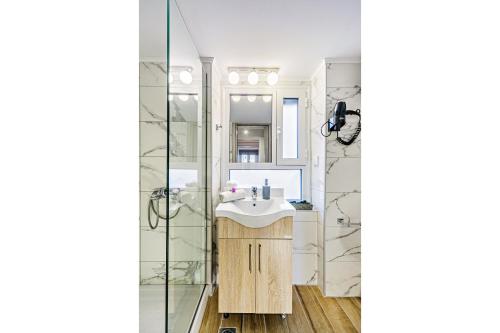 a bathroom with a sink and a shower at Ionian Citizen Atelier in Corfu Town