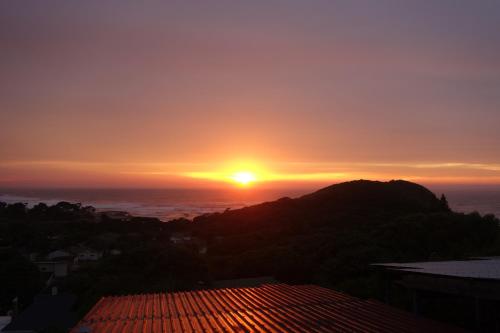 a sunset from the roof of a building at Eagles Nest hostel plus self catering private units in Coffee Bay
