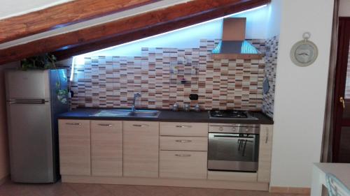 a kitchen with a sink and a stove at La Fortezza casa vacanze & appartament in Castelsardo