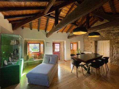 a living room with a table and a couch at AltaVista in Vitorino dos Piães