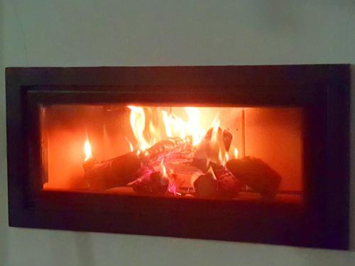 a fire in a fireplace with flames in it at Villa de Lujo en Santa Margarita in Alcaidesa
