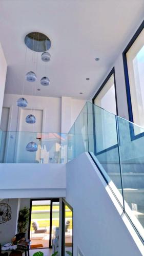 a staircase in a house with glass walls at Villa de Lujo en Santa Margarita in Alcaidesa