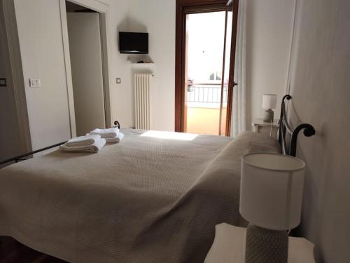 a bedroom with a large bed with towels on it at Casa Angelina in Grado