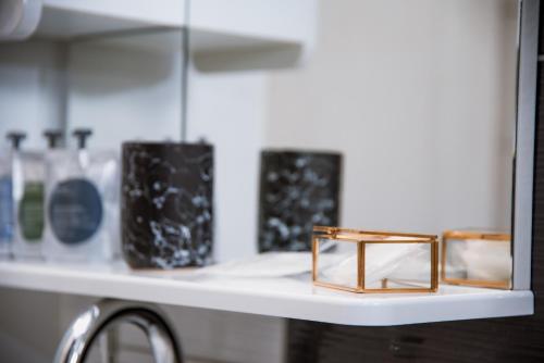 a shelf with vases and a wooden box on it at Guest House Mylan in Ličko Petrovo Selo
