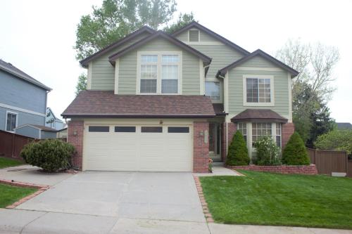 a house with a white garage door at Amazing 4 Bedroom House with nice Backyard in Littleton