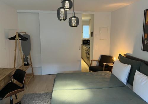 a bedroom with a bed and a desk and a chair at Swiss Art Apartment City Center in Zurich
