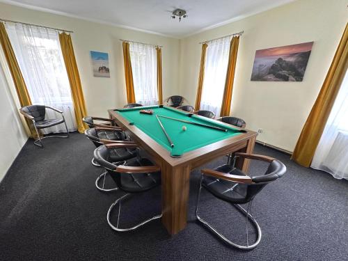 a conference room with a pool table and chairs at Vila Vlčí Hora in Krásná Lípa