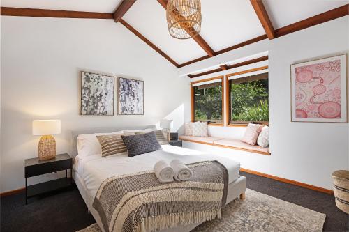 um quarto com uma cama grande e uma janela em Hinterland family getaway em Maleny