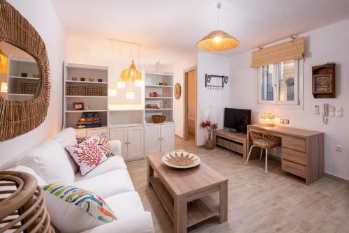 Телевизор и/или развлекательный центр в Olivea Premium Holiday Homes