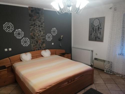 a bedroom with a bed with two pillows on it at apartmaji Renc in Renče