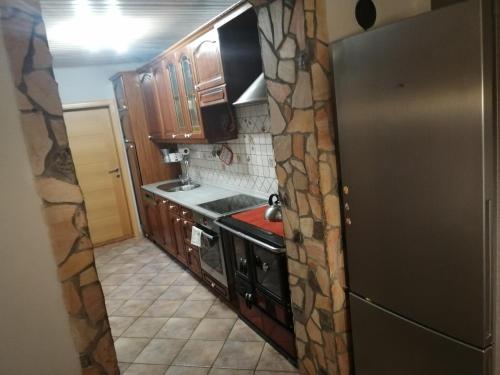 eine Küche mit einem Herd und einem Kühlschrank in der Unterkunft apartmaji Renc in Renče