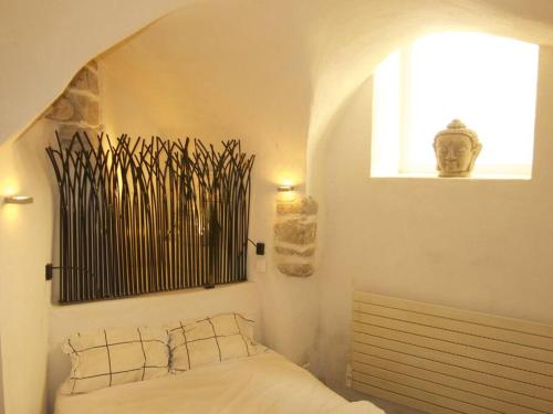 una camera da letto bianca con un letto e una finestra di Le Studio 04 Ramatuelle Vieux Village a Ramatuelle