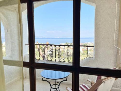 a view from a window of a balcony with a table at Ξενώνας Vasiliki in Vathí