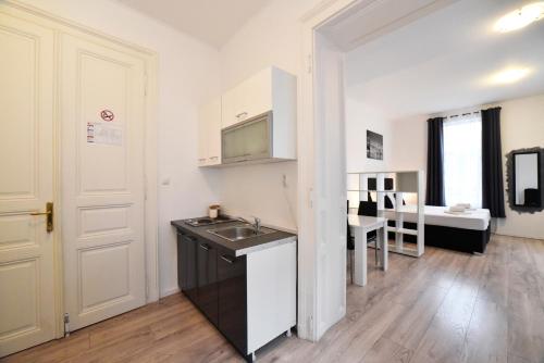 a small kitchen with a sink and a table at Virtus Apartments and Rooms with Free Private Parking in Zagreb