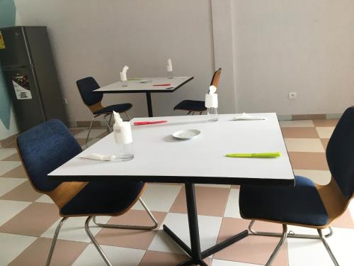 a white table and chairs with a computer mouse on it at Residence MaryHouse - Free Breakfast and Taxi From Airport in Cotonou
