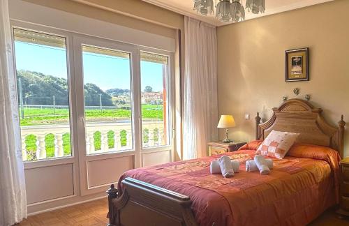 a bedroom with a bed and a large window at La Mies de Vallegon - 1801 in Isla
