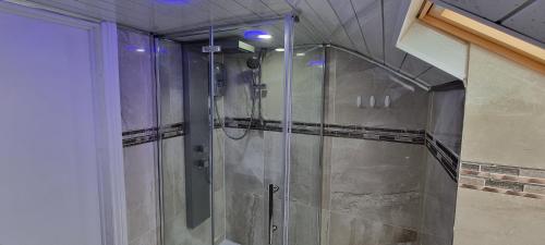 a shower with a glass door in a bathroom at Spacious Large House - Very close to M1 - Walking distance to L&D Hospital - Contractor Friendly - Large groups in Luton