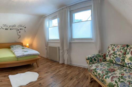 a living room with a couch and a window at Le Bain du Corbeau - Schwarzwald-Villa Alpirsbach in Alpirsbach