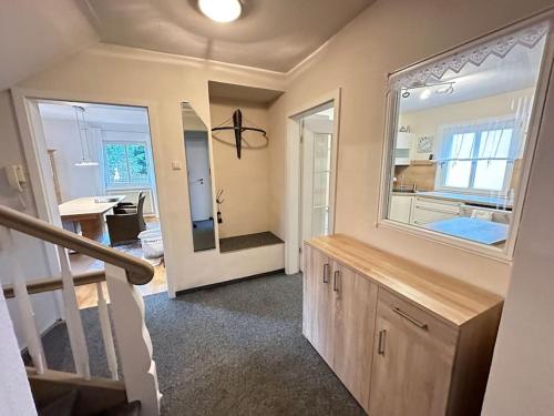 a bathroom with a large mirror and a sink at Le Bain du Corbeau - Schwarzwald-Villa Alpirsbach in Alpirsbach