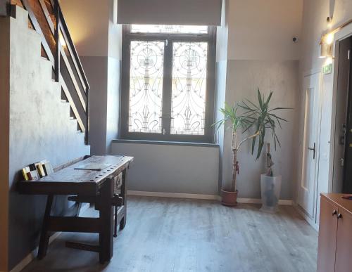 a room with a window and a table and a plant at APARTMENT STAZIONE in Bergamo