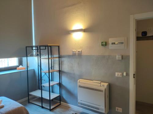 a room with a wall with a book shelf and a bed at APARTMENT STAZIONE in Bergamo