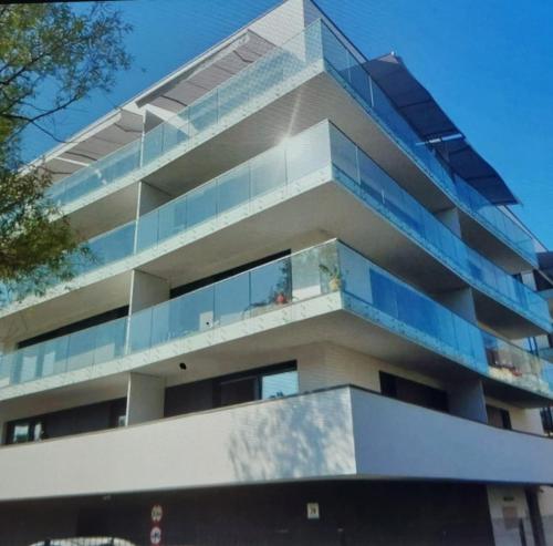 an apartment building with glass balconies on it at Helski azyl in Hel