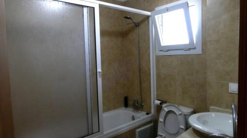 a bathroom with a shower and a toilet and a sink at Apartment Amira Smir in Riffiene