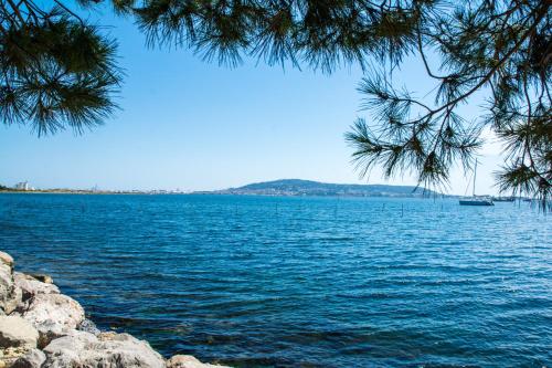 - une vue sur une grande étendue d'eau avec un bateau dans l'établissement Villa Waterfront - Villa with spectacular views and direct access to the laguna, à Balaruc-les-Bains