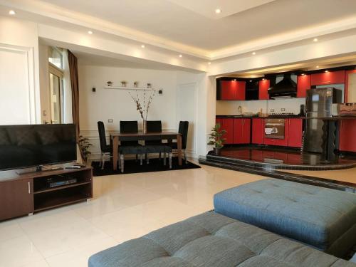 a living room with a couch and a dining room at Mermaid House in Alexandria