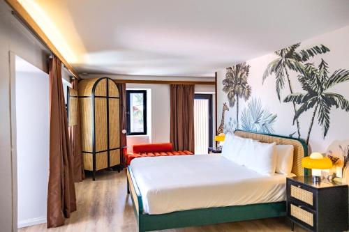a bedroom with a bed and a palm tree mural at The Pink Palm Hotel - Adults Only in Charlotte Amalie