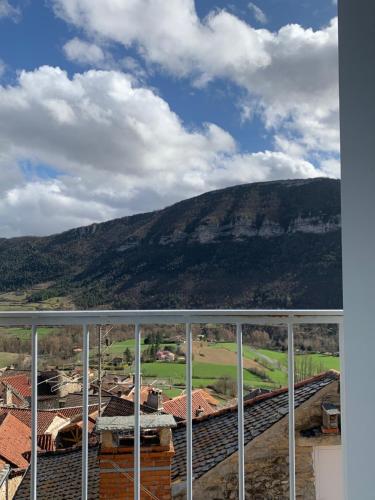 a view of a mountain from a window of a building at Gîte l'oustal de la fontaine Grand Causses et Gorges du Tarn in Mostuéjouls