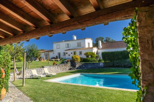 a villa with a swimming pool and a house at Country Village Senses - Quinta Exclusiva in Reguengo Grande