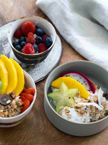 three bowls of fruit and nuts on a table at Tallowwood House Luxury Bed & Breakfast in Port Macquarie