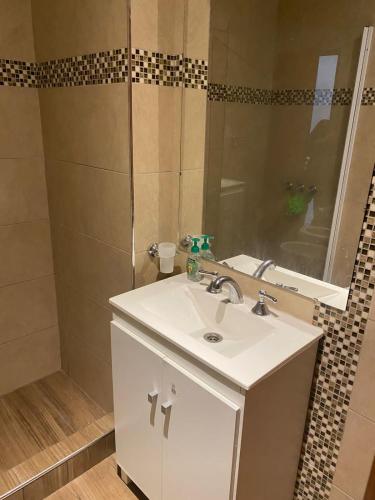a bathroom with a white sink and a mirror at Dpto 15 - Colon - 2 DORMITORIOS - PQ ALQUILERES TEMPORARIOS in Colón