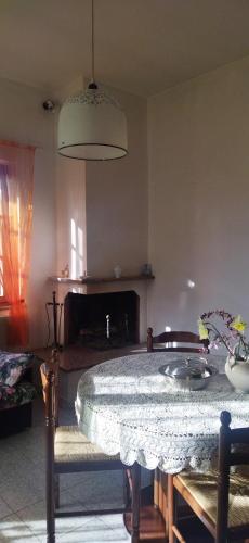 a living room with a table and a fireplace at Nonna Nesti in Cortona
