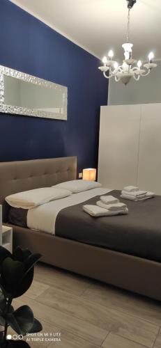 a bedroom with a bed and a blue wall at Urban Loft in Trieste