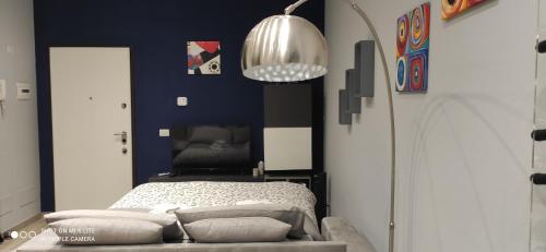 a bedroom with a bed and a blue wall at Urban Loft in Trieste