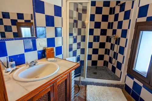 a bathroom with a sink and a shower at Casa de Luz in Casares
