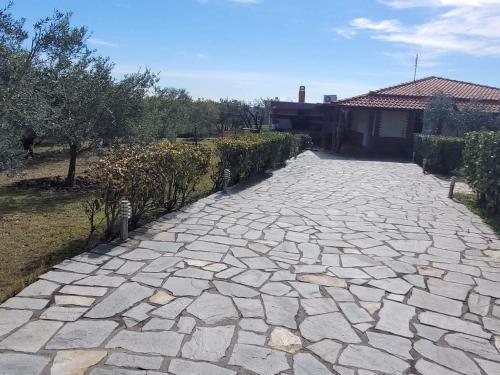 a stone driveway in front of a house at Narcis House in Thessaloniki