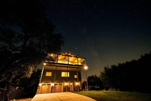a house with lights on top of it at night at Hm w/IslandView-Boat & GolfCart rental Available! in Canyon Lake