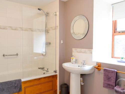 a bathroom with a sink and a shower at Old Mill Cottage in Blair Atholl
