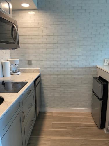 a kitchen with a sink and a counter top at The Victorian Condo/Hotel in Galveston