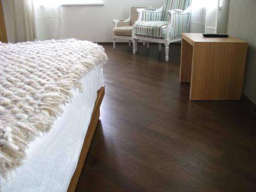 a bedroom with a bed and a table and chairs at Hotel Suite Inn in Udine