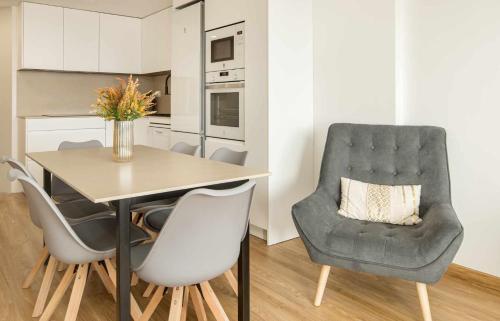 a dining room with a table and a chair at Apartamento Elurra Formigal in Formigal