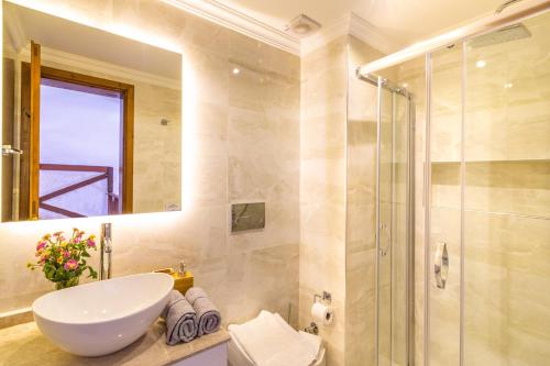 a bathroom with a sink and a shower at SONSUZ in Kalkan