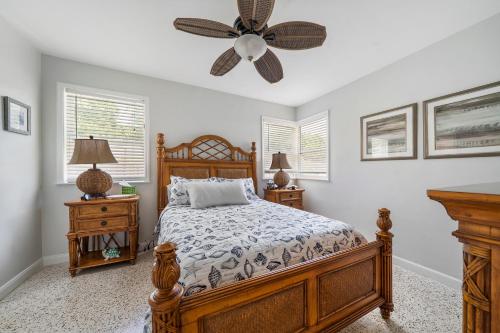 a bedroom with a bed and a ceiling fan at Florida Seaside Get Away- 50 Steps to Beach in Boynton Beach