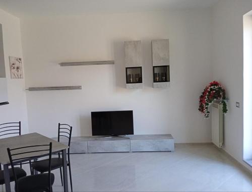 a living room with a tv on a white wall at B&B GERMANY di Lucia in Caselle in Pittari