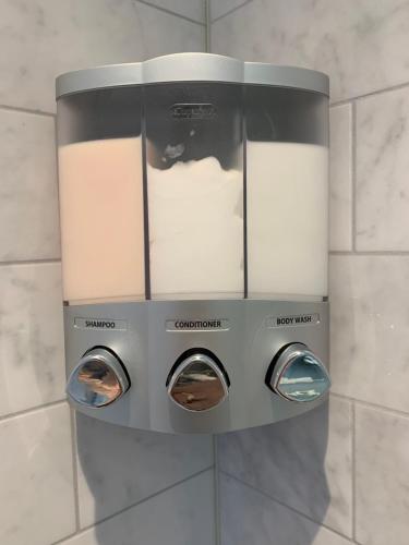 a control panel on the wall of a bathroom at Le Rétro Chic à Mont-Tremblant in Mont-Tremblant