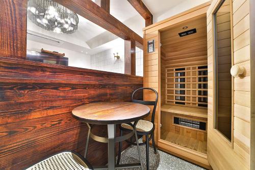 a small table in a room with a wooden wall at Hotel February Tongyeong Jukrim in Tongyeong