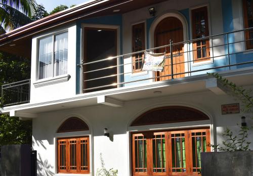 a house with a flag hanging on a balcony at Jayathissa Villa 